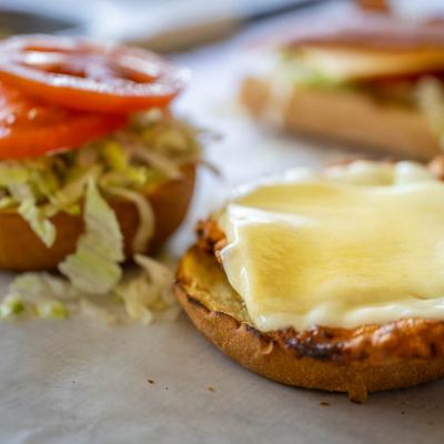 Open faced sandwich, with lettuce, tomato, and cheese.