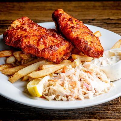 Beer battered cod fish served with fries and coleslaw.