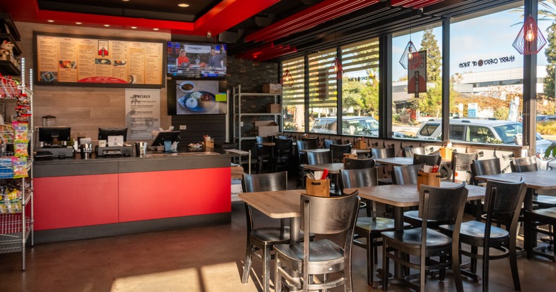 Food counter on left, diner area on right, tables, chairs