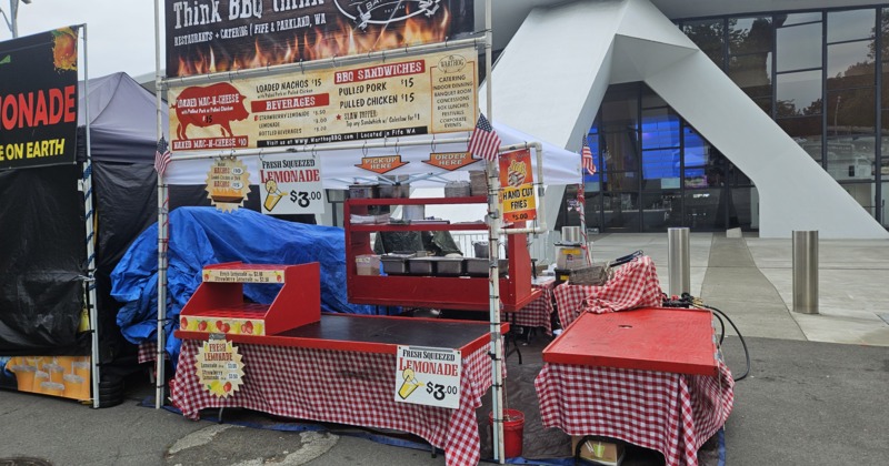 Closed BBQ food stall with lemonade signs