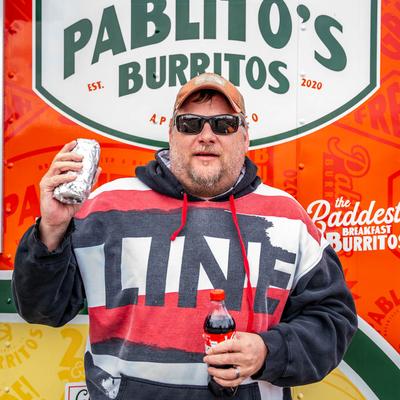 Customer holding a burrito.