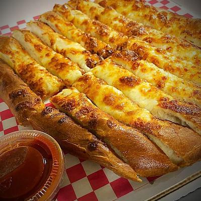 Served pizza with sauce on the side.