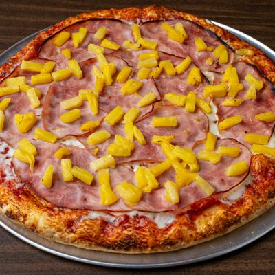 Hawaiian Pizza topped with ham and pineapple.