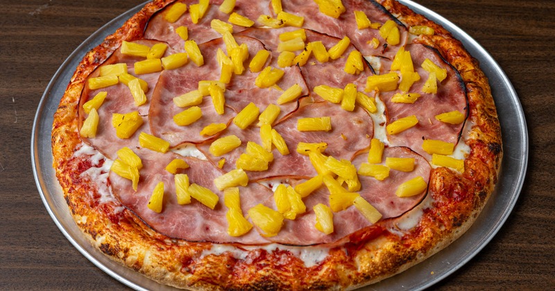 Hawaiian Pizza topped with cheese, pineapple and ham