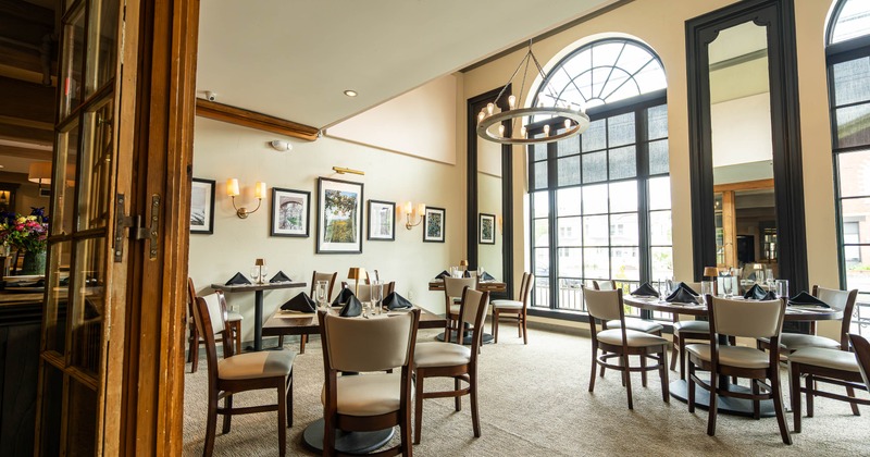 Elegant restaurant dining area with large arched windows