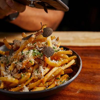 A plate of Parmesan Garlic Truffle Fries.