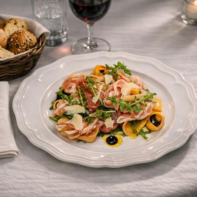 Tortellini pasta dish featuring prosciutto, arugula and parmesan cheese.