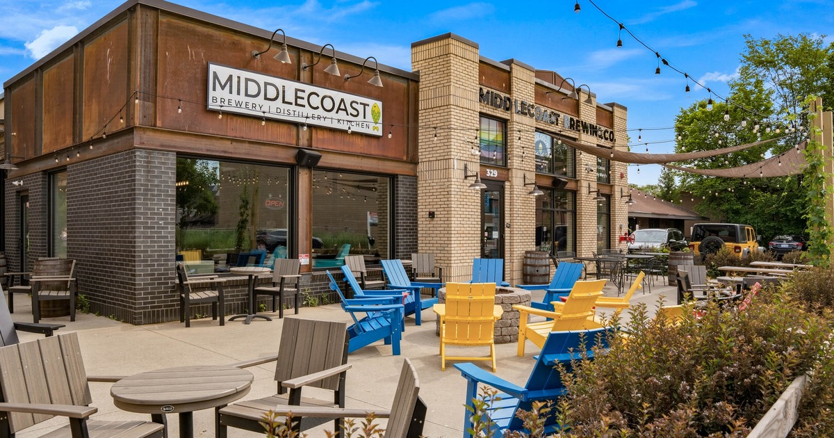 Outdoor seating area with lounge chairs around a fire pit