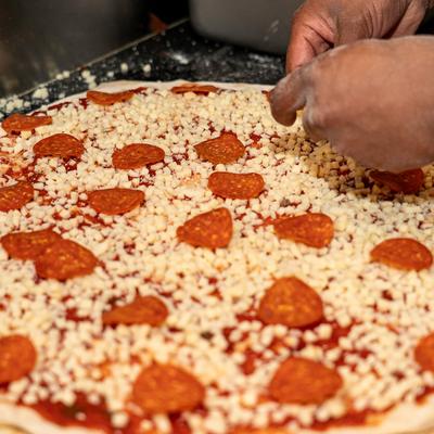 Making of pepperoni pizza.