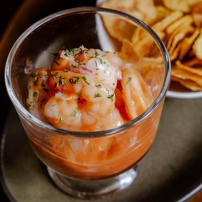 Shrimp cocktail served with chips on the side.