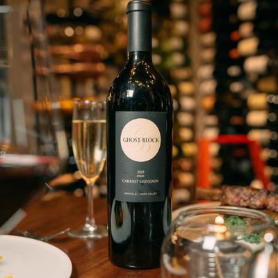 Cabernet Sauvignon bottle on a table in a wine room.