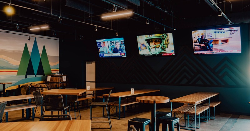 Interior, seating area, long tables wooden top tables and benches, high seating tables