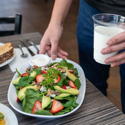 Restaurant staff member standing by a table with assorted dishes. close up of the food