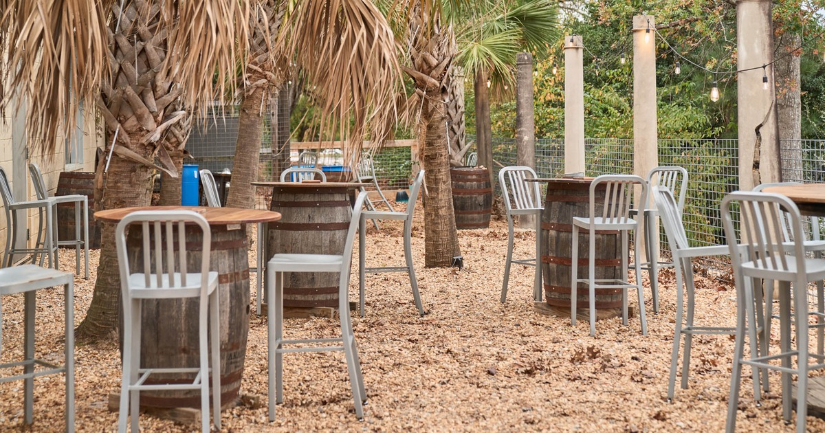 Exterior, tall tables and bar stools, palm trees