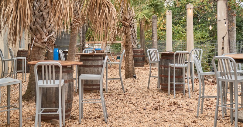 Exterior, tall tables and bar stools, palm trees