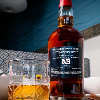 A strong drink in a bottle and a glass.