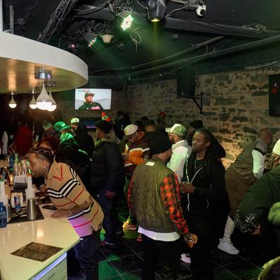 Crowd socializing in a lively bar.