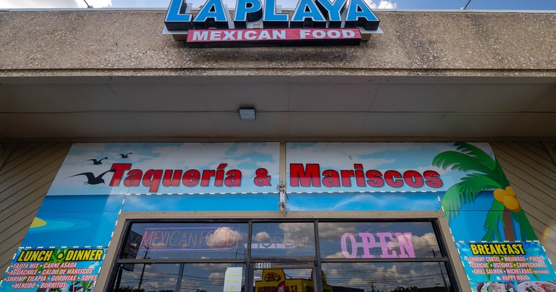 Exterior, front of restaurant low angle to entrance and sign