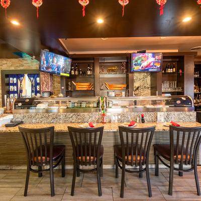 Food counter, preparation diner table, chairs, screens behind.