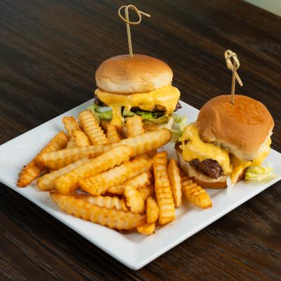 Waygu brisket sliders with lettuce, melted cheese and a side of fries.