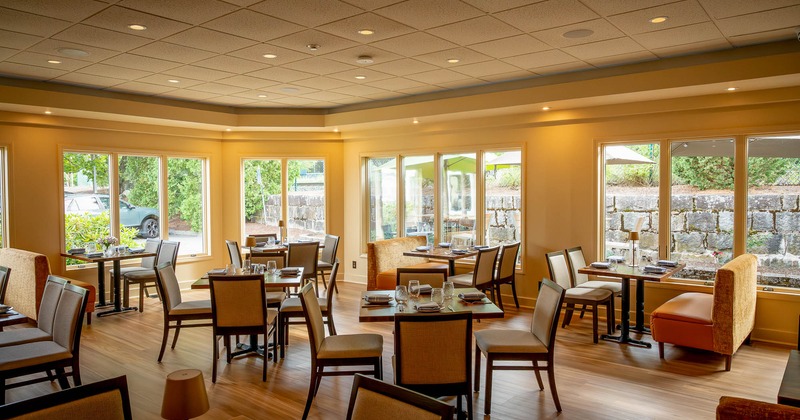 Interior, tables all lined up with glasses and tableware