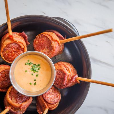 Bacon Wrapped Andouille Lollipops with a sauce dip