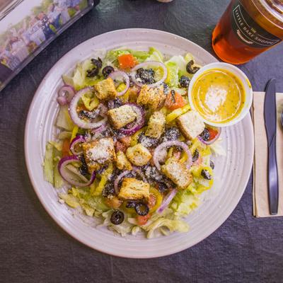 House Salad with fresh vegetables, grated cheese, croutons and a side of dressing.