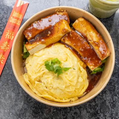 Glazed pork ribs with Chinese cabbage, garlic sauce, rice, and scrambled eggs.