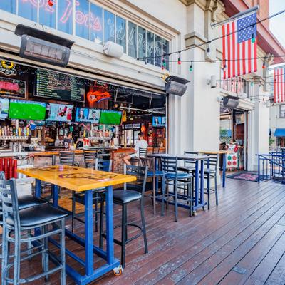 Bar's outdoor patio area in a city street setting.