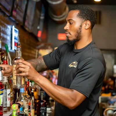 A person working behind the bar.