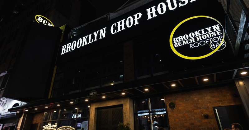 Exterior, night view to restaurant, entrance, sign above