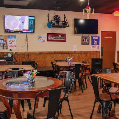 Diner room, tables and chairs, tv screens above