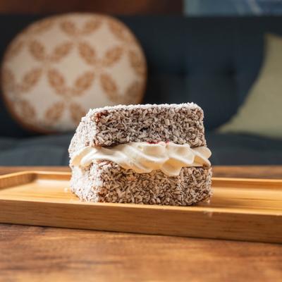 Chocolate cream cake, dusted in coconut flakes.