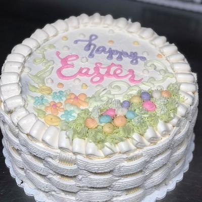 Easter cake with pastel icing and candy eggs.