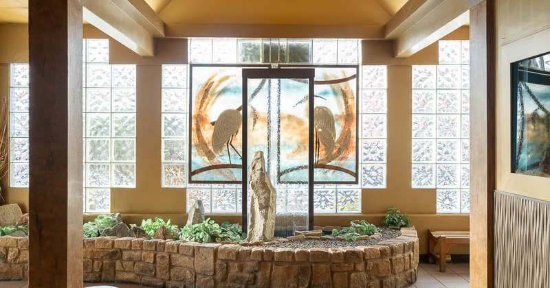 Interior, a stone wall featuring a glass fountain wall as its centerpiece