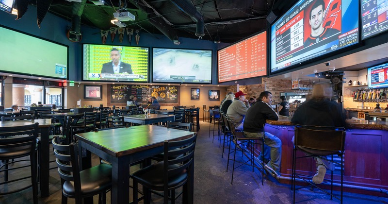 Interior, tables and chairs,  guest sitting at the bar on the right
