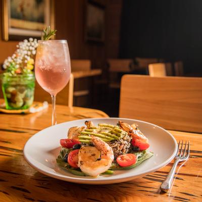 Avocado, wild rice and shrimp salad plate with a cocktail drink