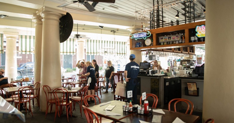 Interior, seating space around a bar, staff in action