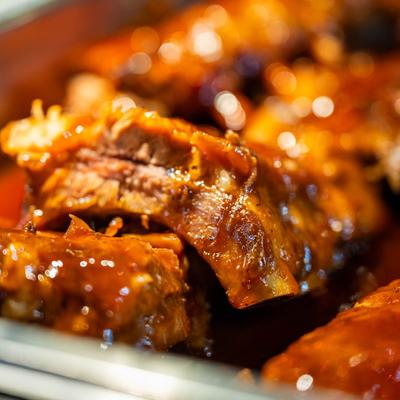 Pork ribs coated in a sauce, close up.