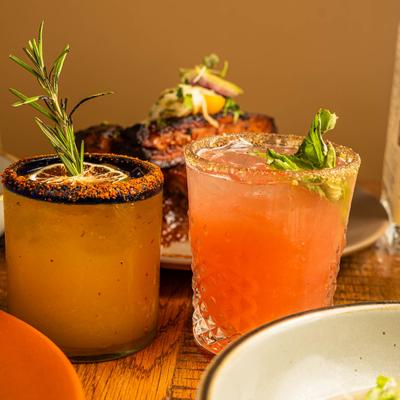 Two cocktails and food.