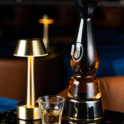 Shot and bottle of Clase Azul Tequila Gold.