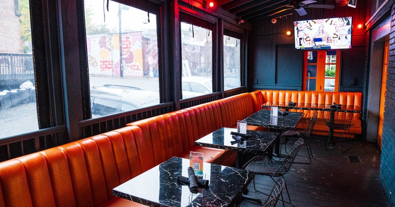 Interior, upholstered leather seating with dining tables and seats