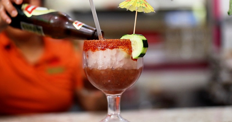 Beverage being pured from the bottlle into a cocktail glass