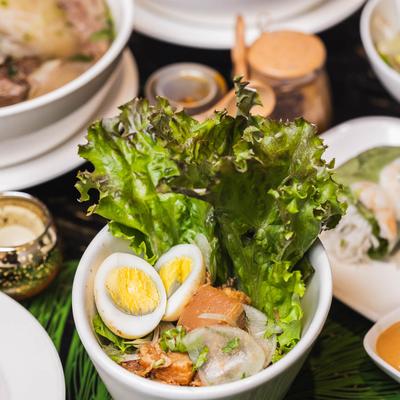 A pot with braised pork belly and hard boiled egg served with rice.