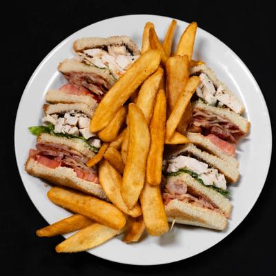 Delicious Club Sandwich served with fresh french fries..