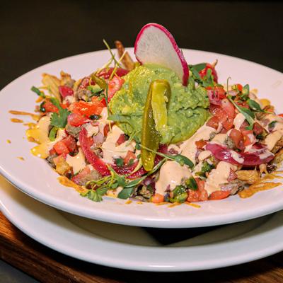 Loaded fries, with cheese, steak bits, chipotle sauce, pico de gallo, and guacamole.