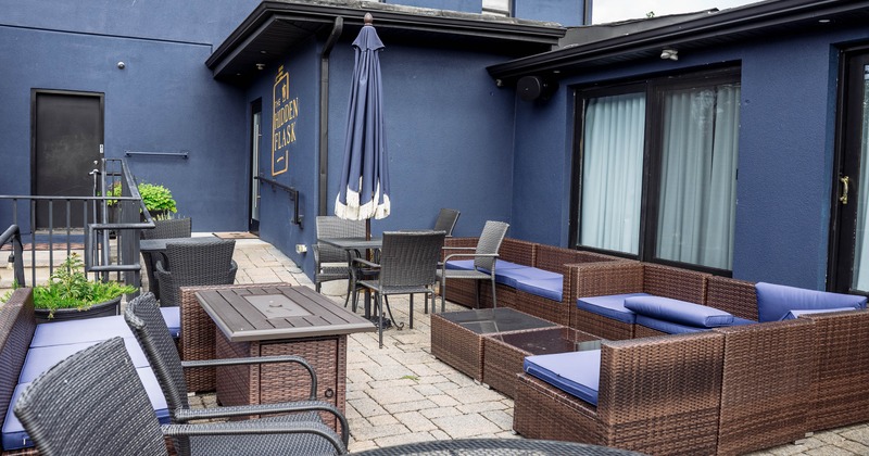 Outdoor seating area with wicker furniture and dark blue cushions