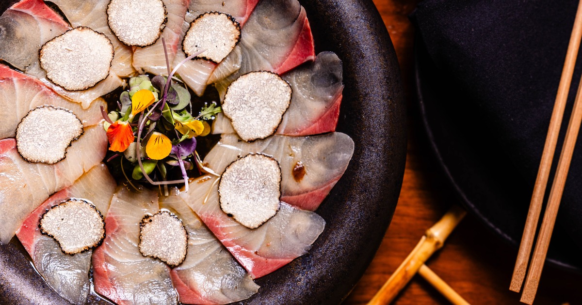 Hamachi carpaccio topped with slices of white truffle