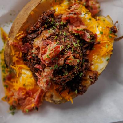 Loaded baked potato, with  butter, sour cream, bacon bits, and chives.
