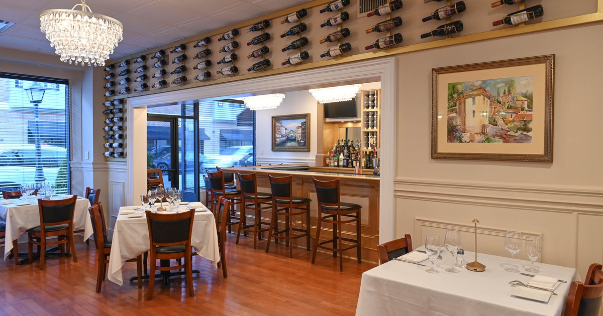 Elegant and cozy interior dining area with dining tables set for guests and bar